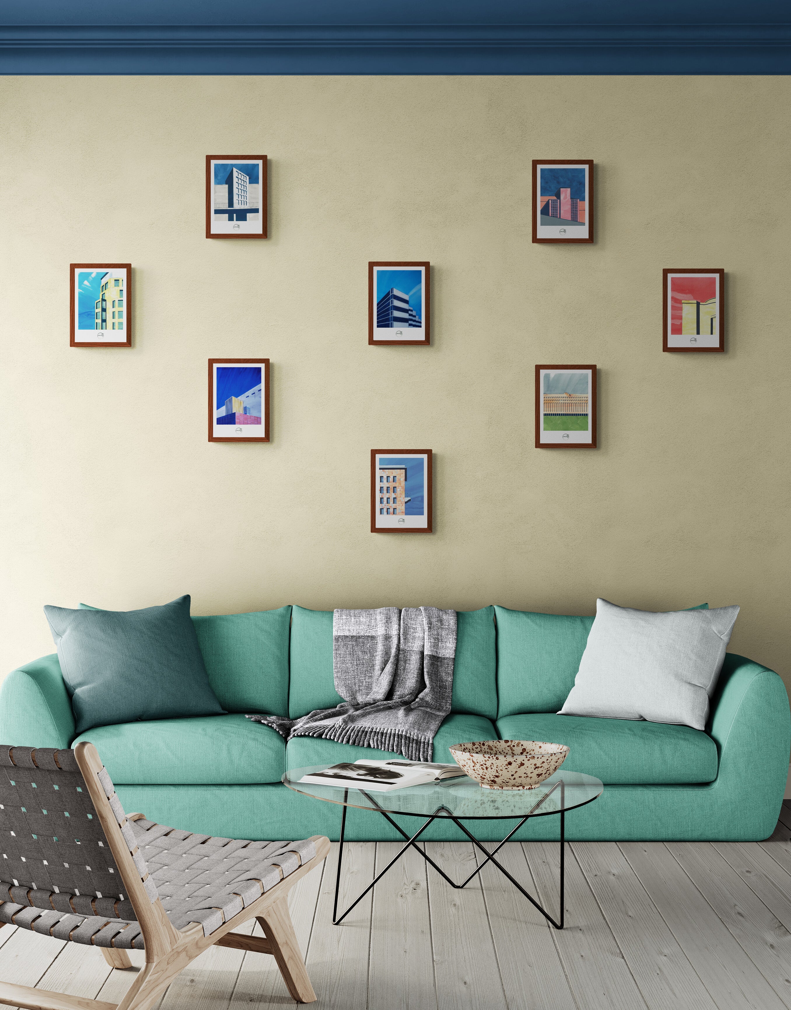 Huit affiches picturales Berlin sur mur beige au-dessus d'un grand canapé vert sur terrasse en bois style bord de mer chic