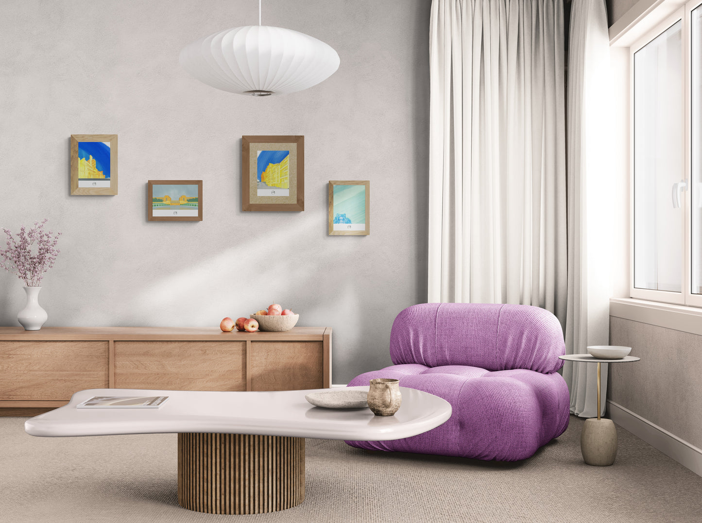 Quatre affiches picturales immeubles Paris dans un salon avec fauteuil en tissu rose design