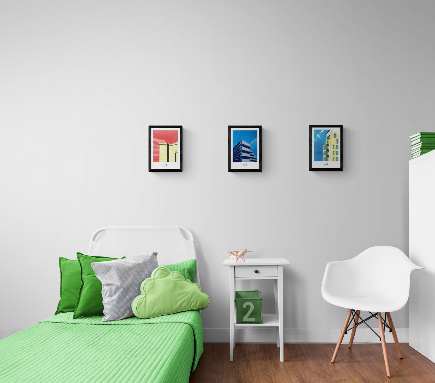 Trois affiches dessins architecture Berlin au-dessus d'un lit avec couverture et coussins verts dans une chambre d'enfant